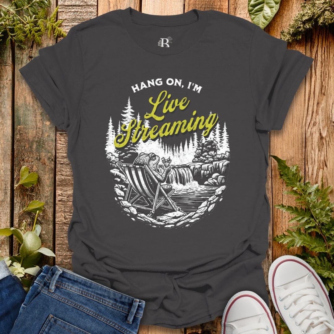 Gray t-shirt with 'Hang on, I'm Live Streaming' graphic on a wooden background
