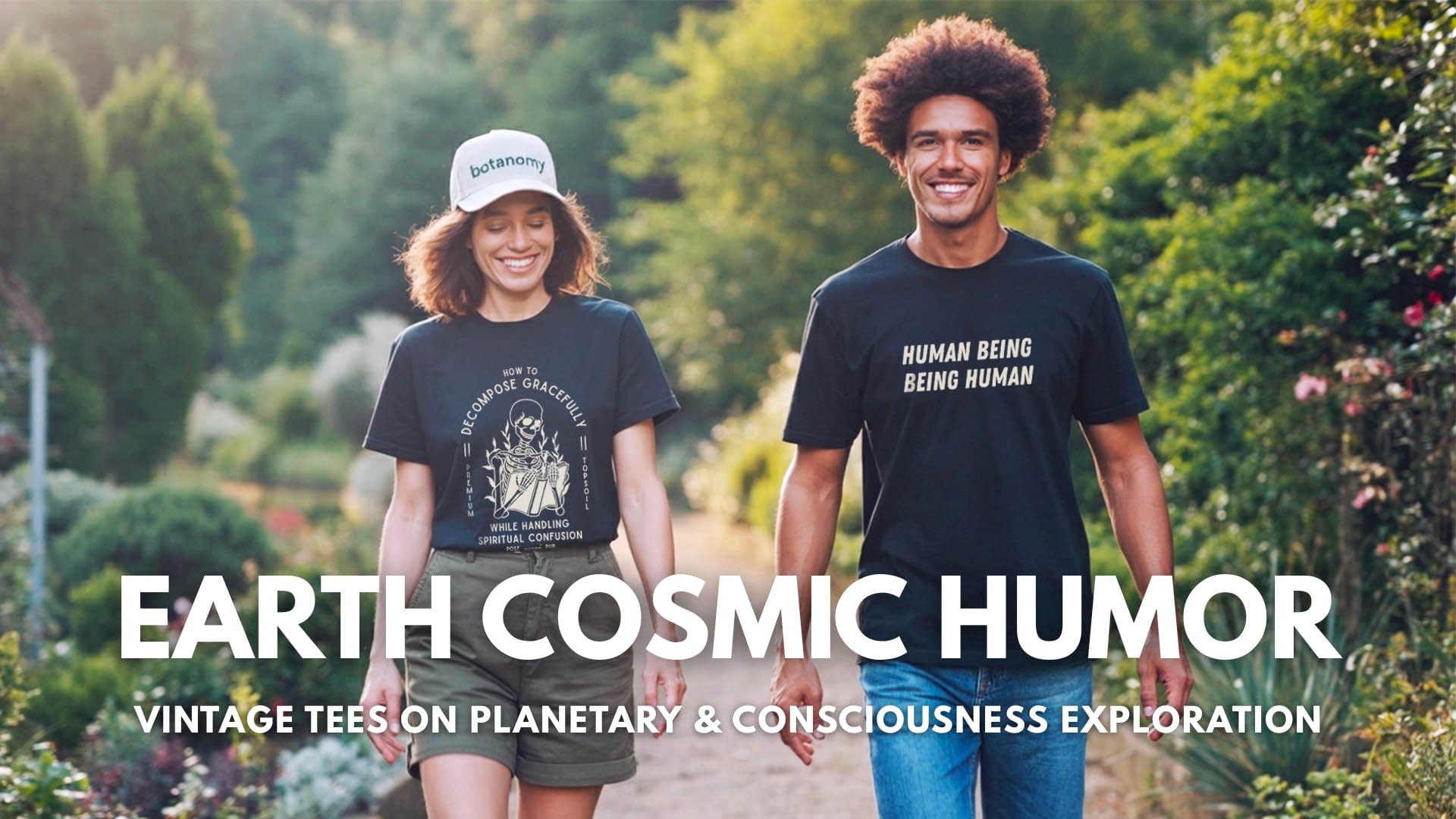 Two people walking outdoors with t-shirts featuring text “earth cosmic humor”, surrounded by greenery.