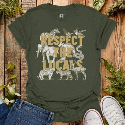Green t-shirt with animal graphics and 'Respect the Locals' text on a wooden background