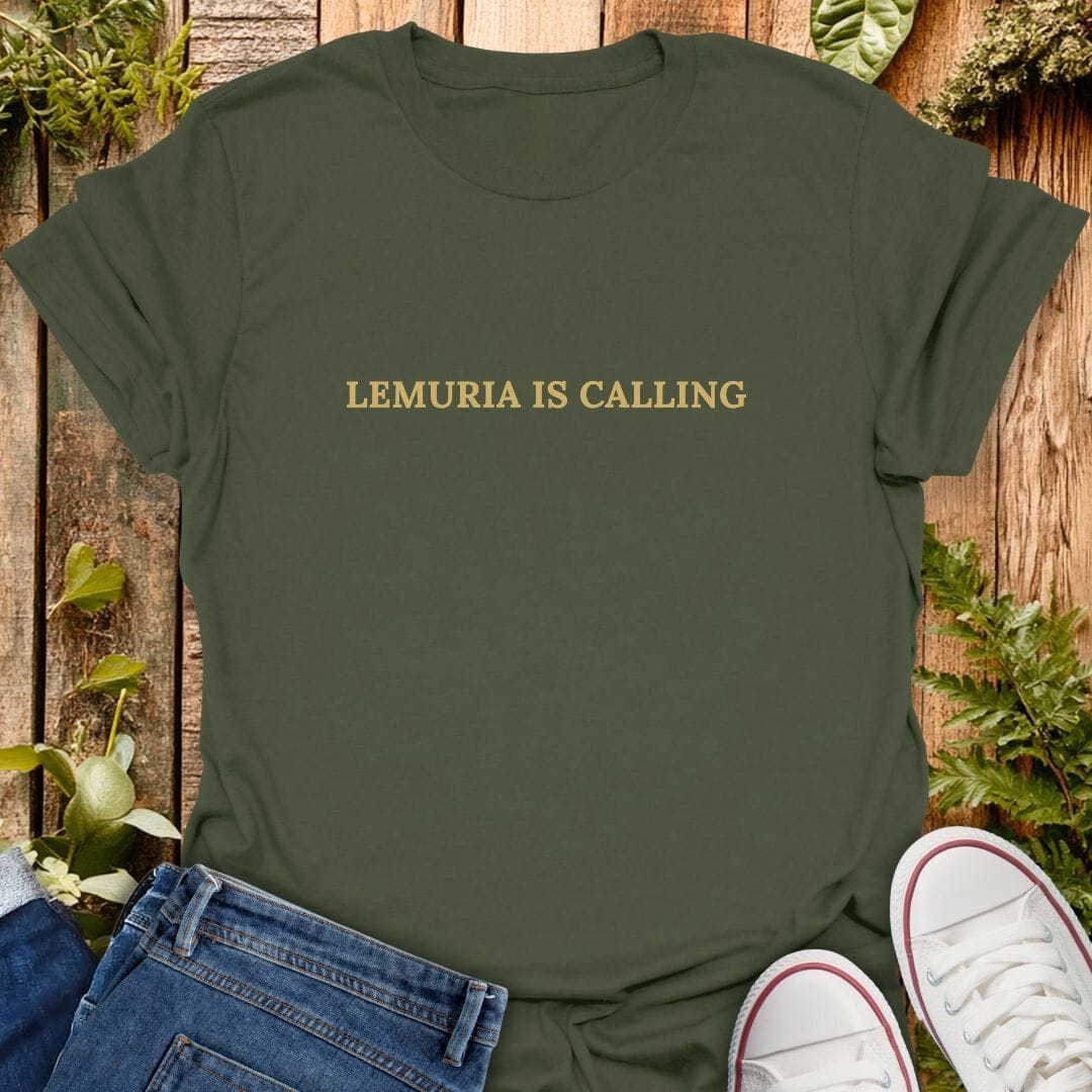 Green t-shirt with 'Lemuria is calling' text on a wooden surface with plants, jeans and sneakers.