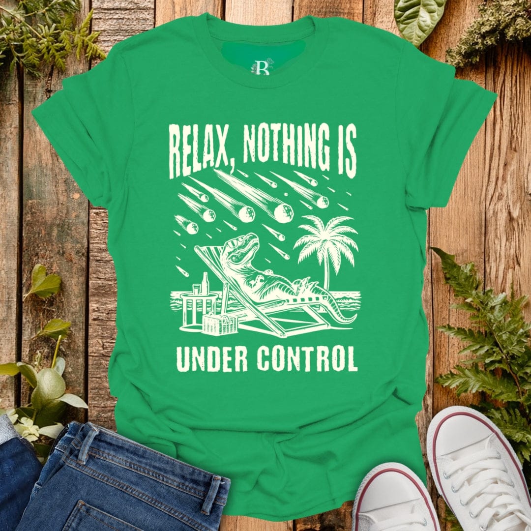Green t-shirt with white graphic and text 'Relax, Nothing is Under Control' on a wooden background.