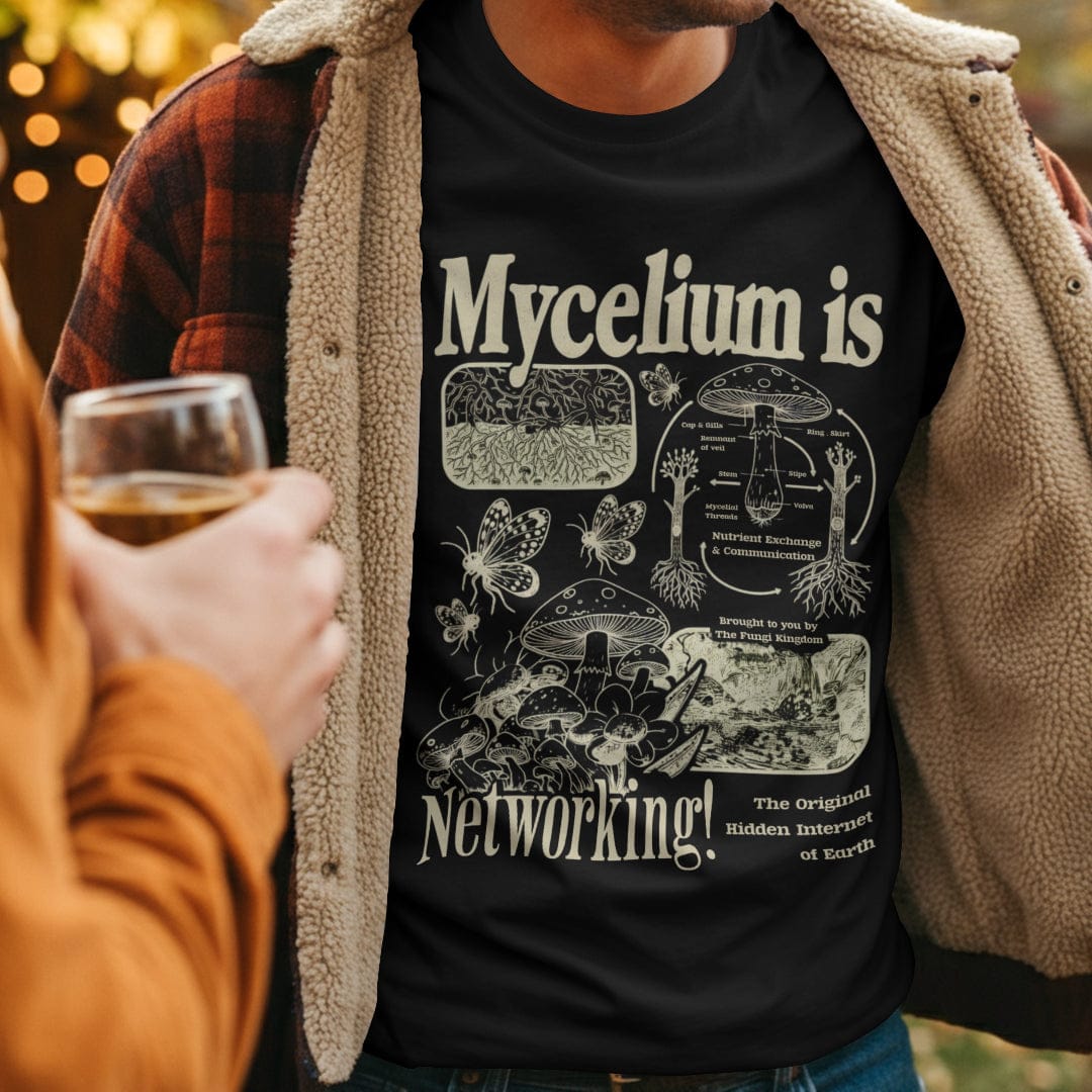 Man wearing a black t-shirt with Mycelium is Networking text and mushroom graphics.