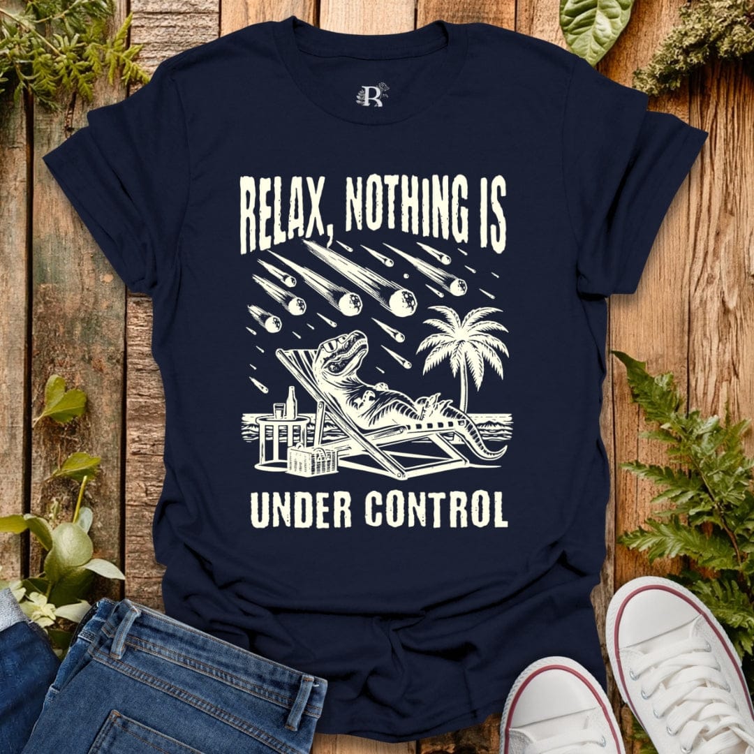 Navy blue t-shirt with white graphic and text 'Relax, Nothing is Under Control' on a wooden surface with plants.