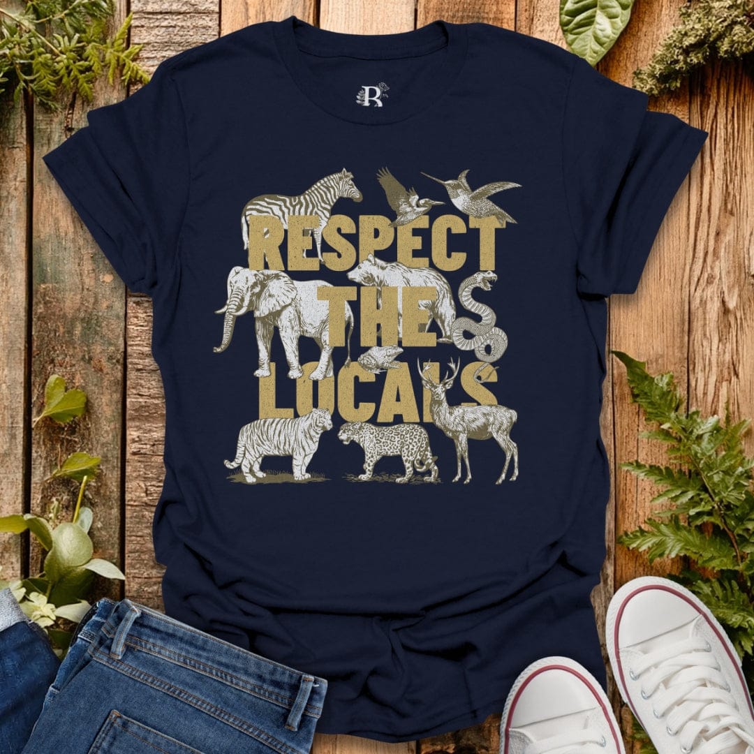 Navy blue t-shirt with animal graphics and 'Respect the Locals' text on a wooden surface.