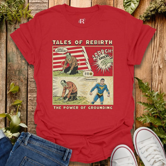 Red T-shirt with comic graphic "Tales of Rebirth" and "The Power of Grounding", showing a monster turning into superhero after grounding with Earth.