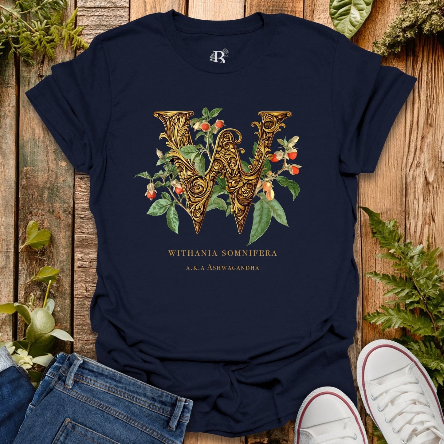 Navy blue t-shirt with decorative letter 'W' design on a wooden surface with plants.