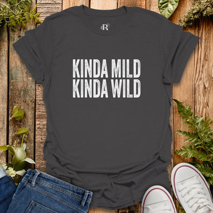 Black t-shirt with 'KINDA MILD KINDA WILD' text on a wooden surface with jeans and sneakers.