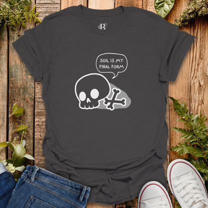 Black t-shirt with skull design and text on a wooden surface with plants.