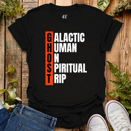 Black t-shirt with text design on a wooden surface with plants