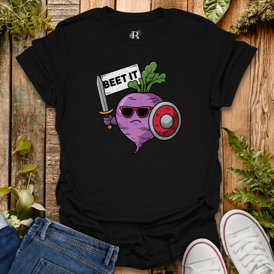 Black t-shirt with a graphic design of a beet holding a sword and sunglasses, surrounded by plants on a wooden surface.