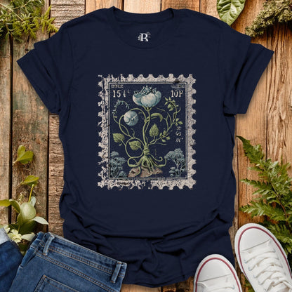 Navy blue t-shirt with floral design on a wooden surface with plants.