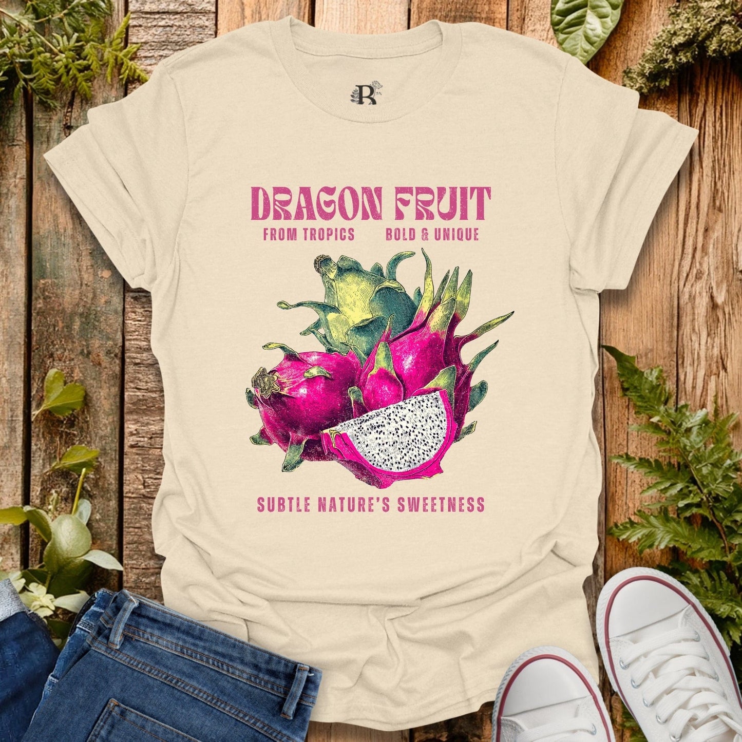 Beige t-shirt with dragon fruit graphic and text on a wooden background