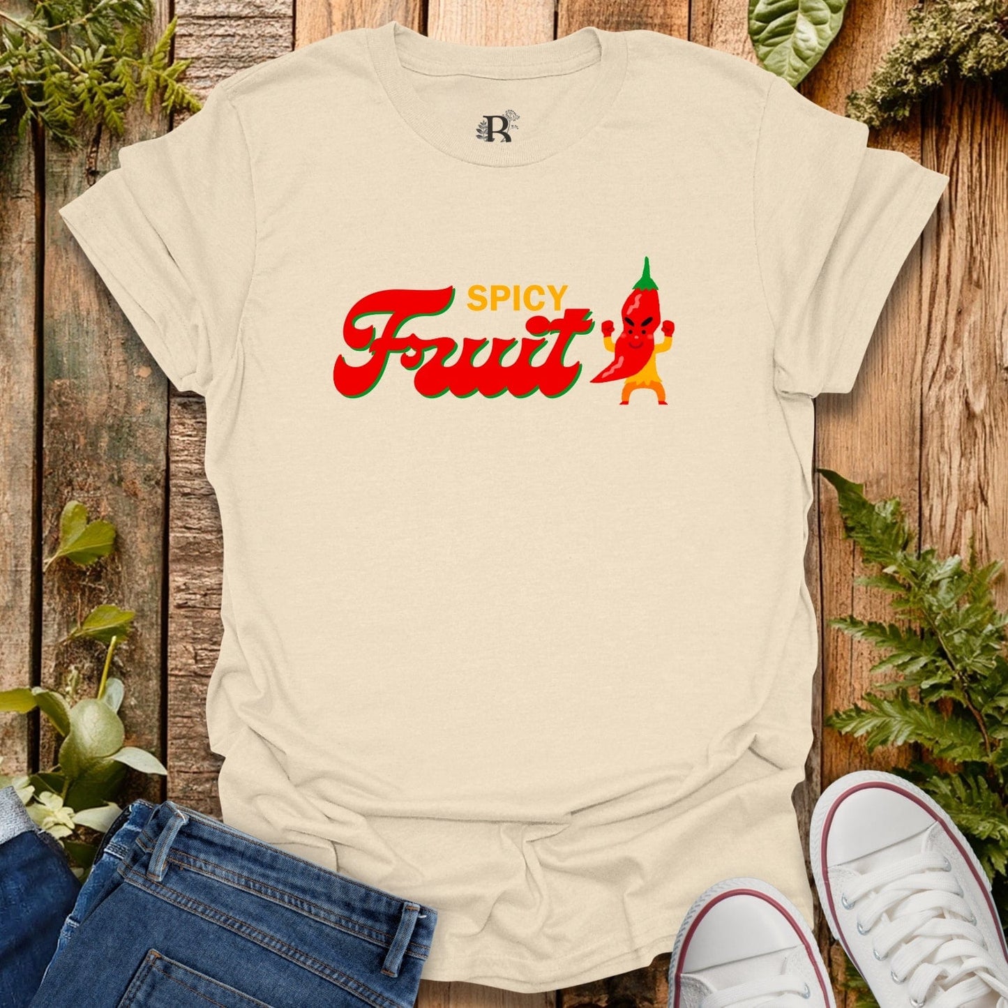 Beige t-shirt with 'Spicy Fruit' graphic design on a wooden background
