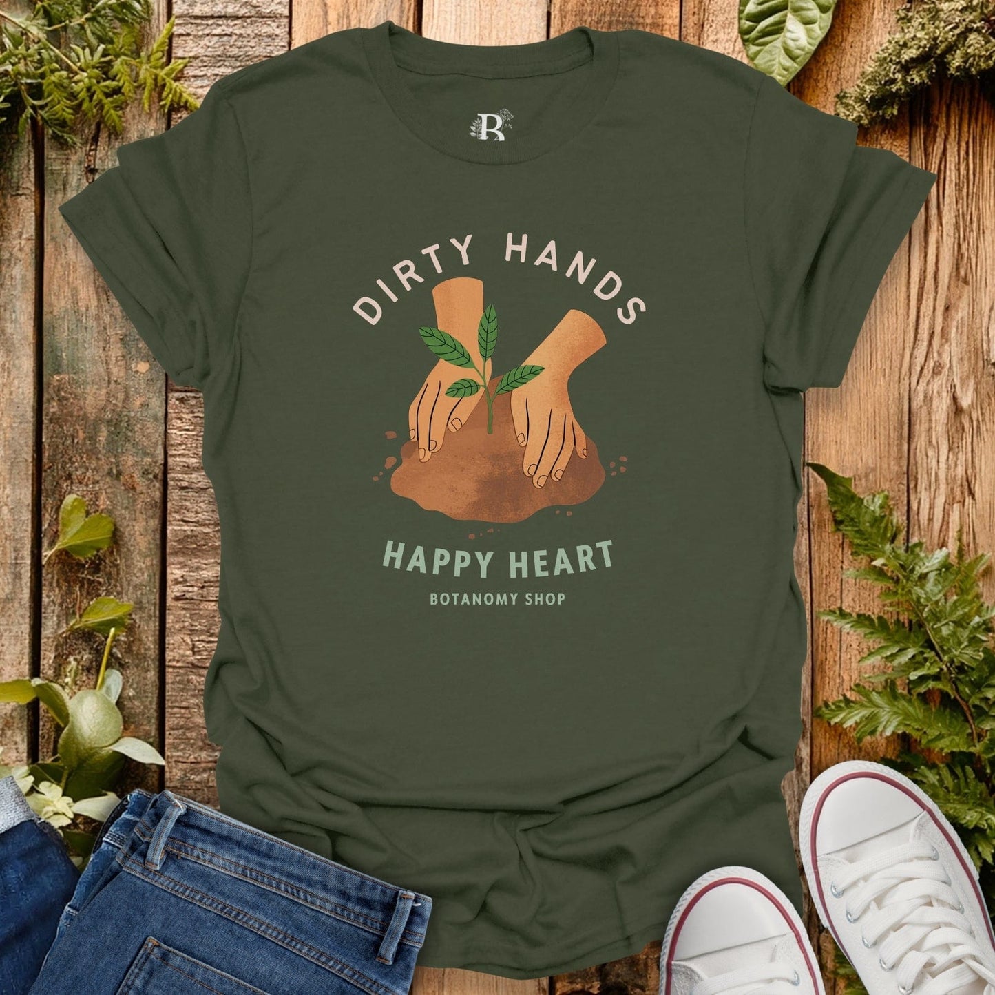 Green t-shirt with 'Dirty Hands Happy Heart' design on a wooden background