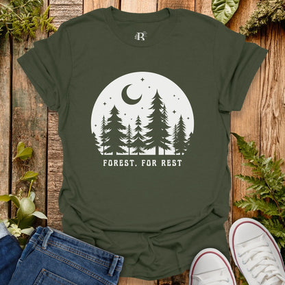 Green t-shirt with forest design and 'Forest. For Rest' text on a wooden background