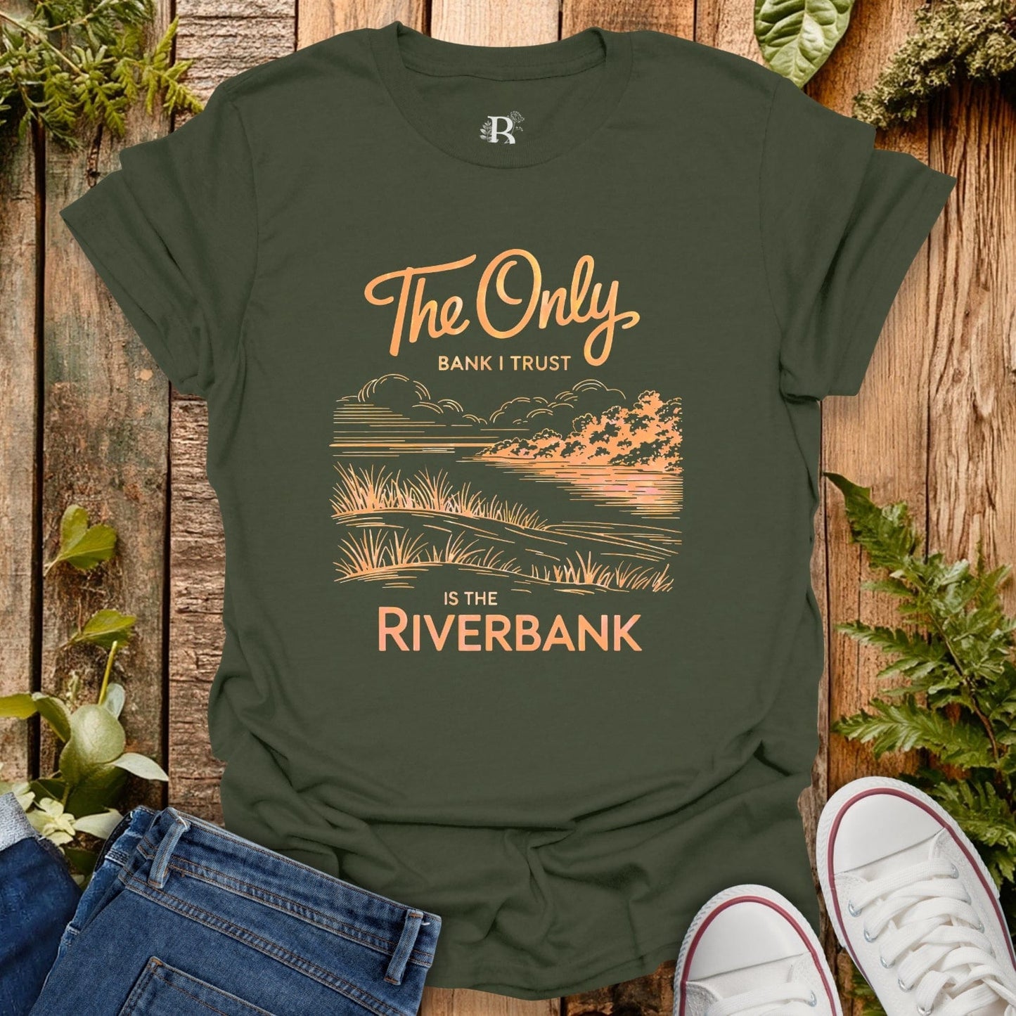 Green t-shirt with nature-themed design and text on a wooden background