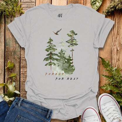 Gray t-shirt with forest design and 'Forest for Rest' text on a wooden background