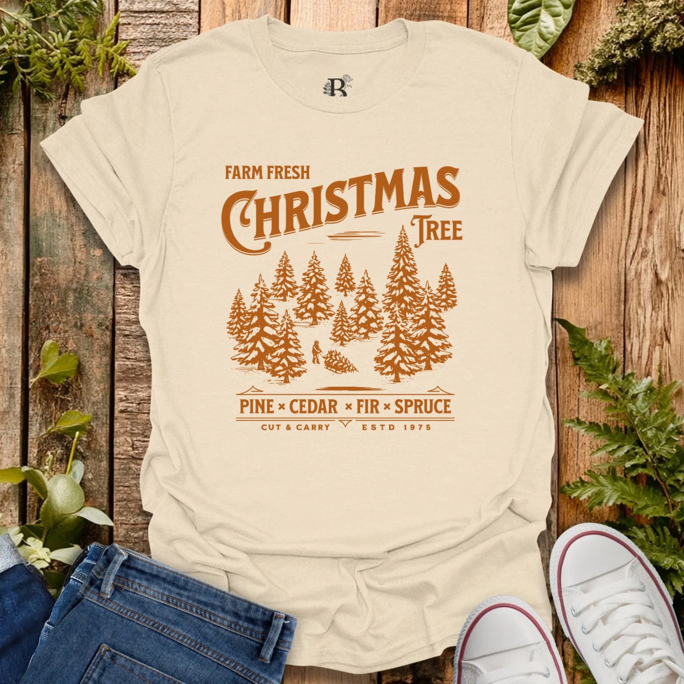 Beige t-shirt with 'Farm Fresh Christmas Tree' design on a wooden background