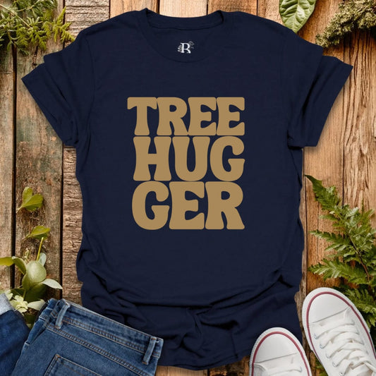 Navy blue t-shirt with 'TREE HUGGER' text on a wooden surface with plants.