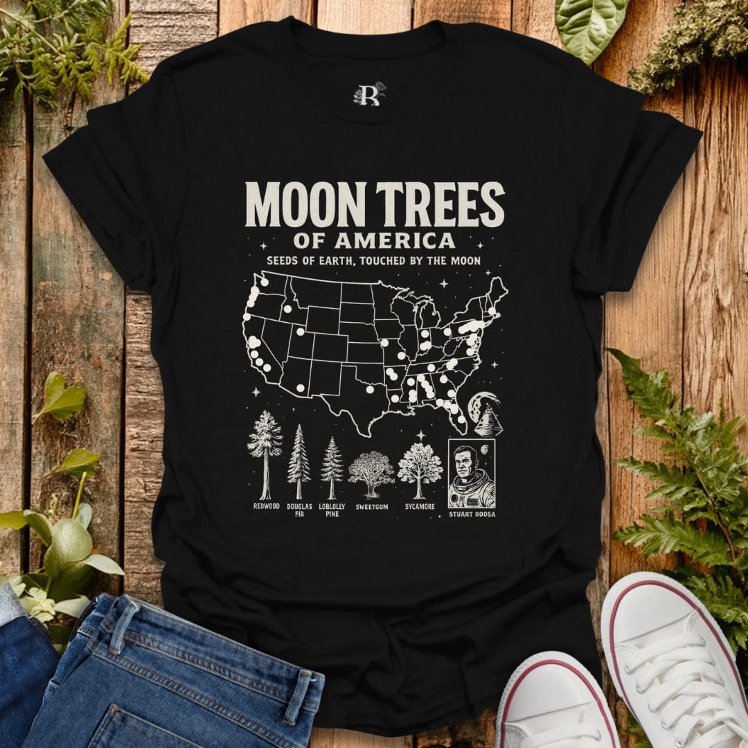 Black t-shirt with ‘Moon Trees of America’ text, and a map of the locations of moon trees, and a comic style photo of astronaut  Stuart Roosa. 