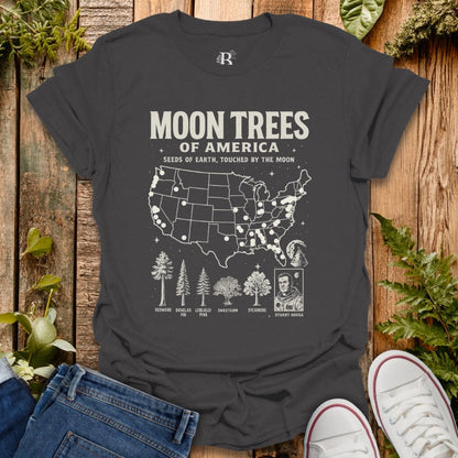 Gray t-shirt with ‘Moon Trees of America’ text, and a map of the locations of moon trees, and a comic style photo of astronaut  Stuart Roosa. 