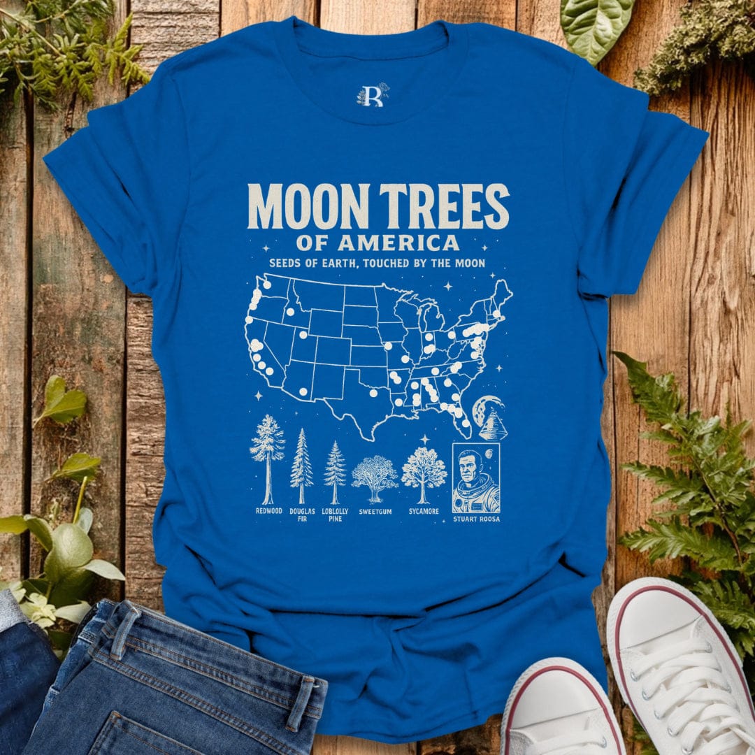 Royal Blue t-shirt with ‘Moon Trees of America’ text, and a map of the locations of moon trees, and a comic style photo of astronaut  Stuart Roosa. 