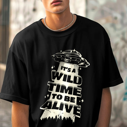 Man wearing black T-shirt with UFO graphic design.